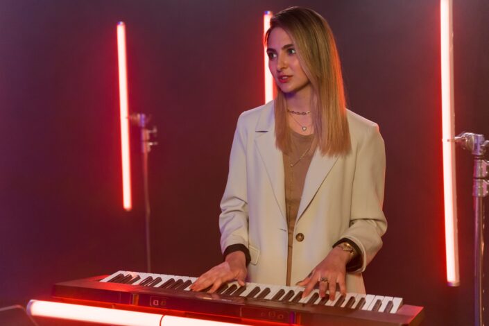 beautiful-woman-in-white-coat-playing-the-piano-