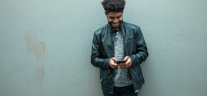 a-man-smiling-while-texting-